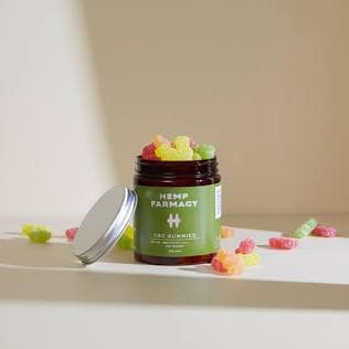 Inside-Out Care: Why True Beauty Sleep Starts with Stress Relief 13 An open amber glass jar filled with colorful premium wellness gummies sitting on a clean studio shelf
